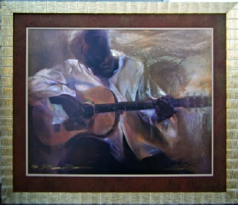 painting of an african-american man playing a guitar in a silver frame with brown matting