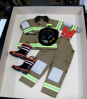 fireman's uniform, including boots, in a shadowbox