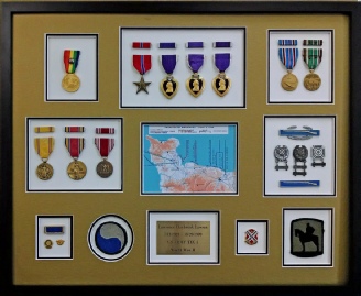 military medals and patches mounted and displayed in a frame