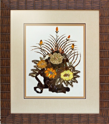 picture of a dried flower arrangement in a wicker frame